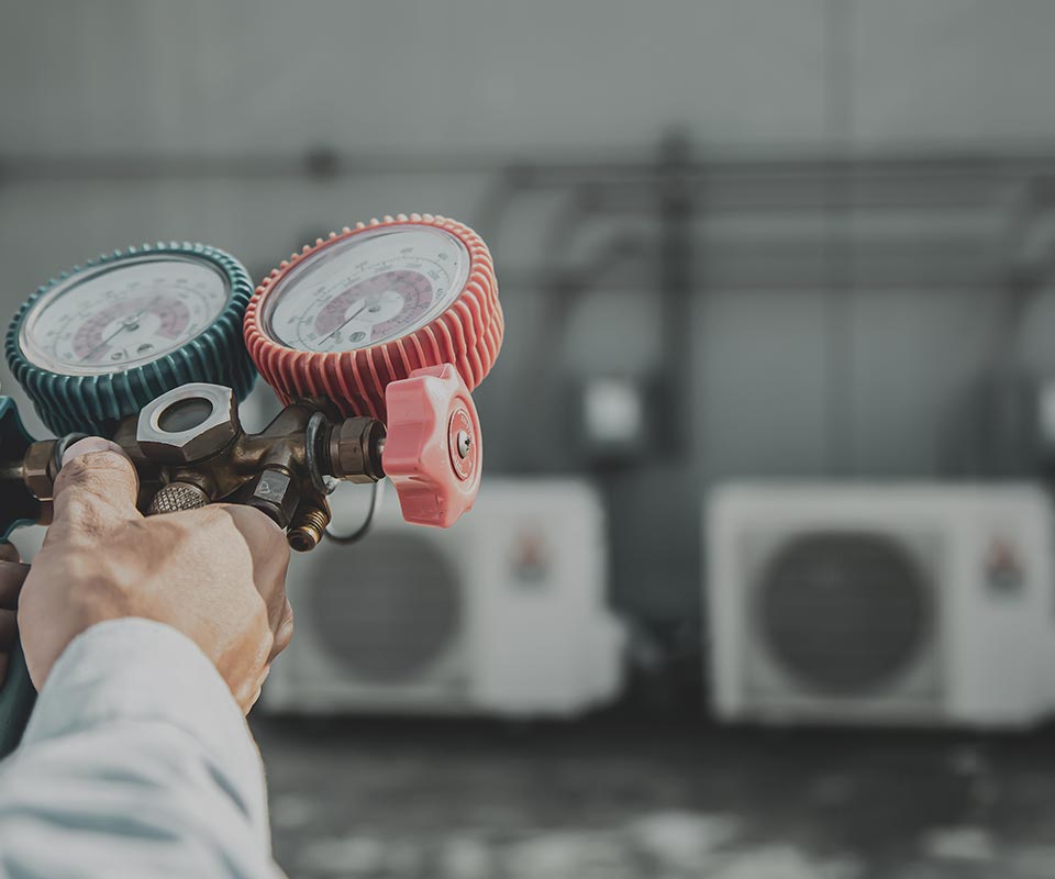 image of man adjusting commercial air conditioning units